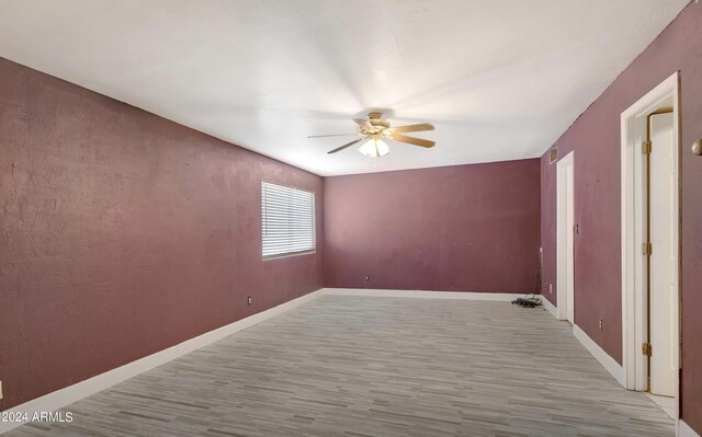 empty room featuring ceiling fan and light hardwood / wood-style flooring