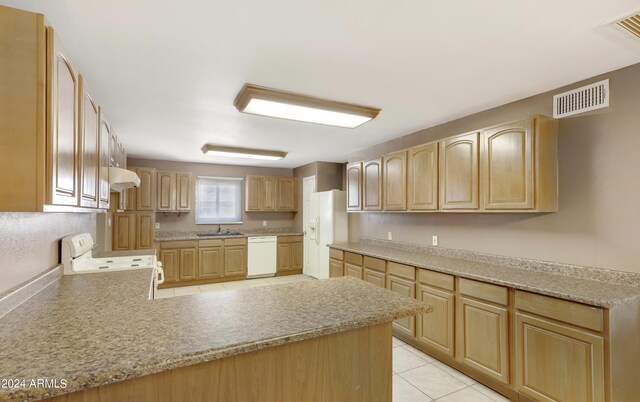 kitchen featuring white appliances, light tile patterned flooring, sink, and light brown cabinets