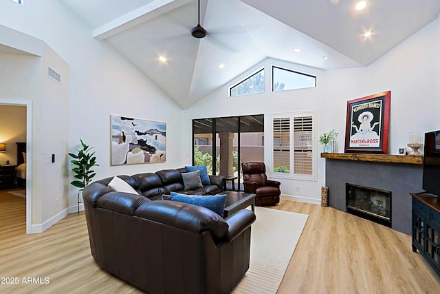 4039 E Paradise Dr, Phoenix, AZ 85028 - living room with wood finished floors, a glass covered fireplace, baseboards, high vaulted ceiling, and recessed lighting