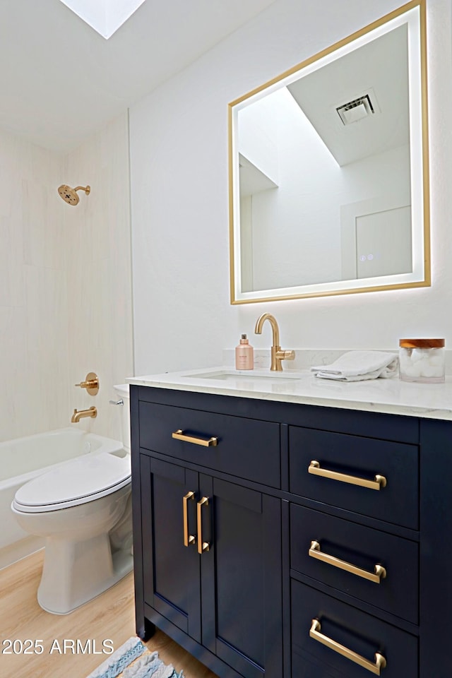 4039 E Paradise Dr, Phoenix, AZ 85028 - full bath featuring toilet, wood finished floors, vanity, and washtub / shower combination