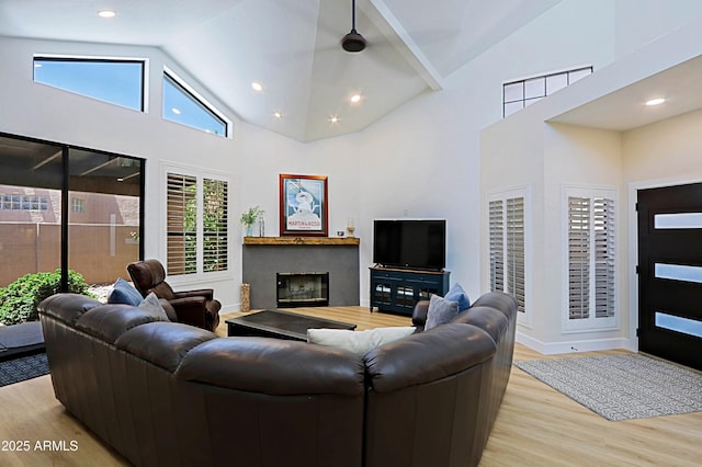 4039 E Paradise Dr, Phoenix, AZ 85028 - living area featuring wood finished floors, high vaulted ceiling, a glass covered fireplace, baseboards, and recessed lighting