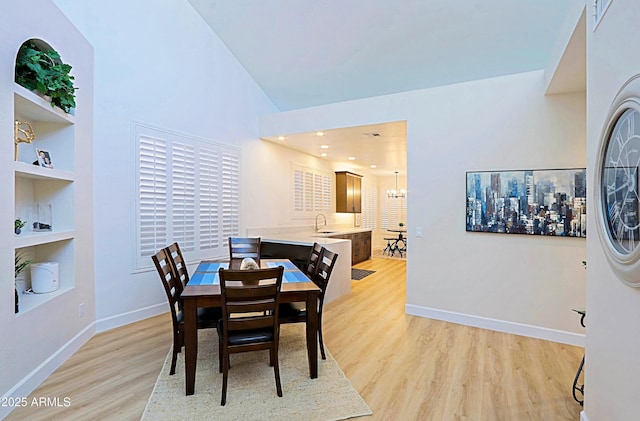 4039 E Paradise Dr, Phoenix, AZ 85028 - dining room featuring built in shelves, light wood-type flooring, baseboards, and a chandelier