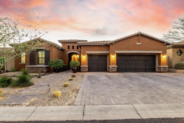 mediterranean / spanish house with a garage