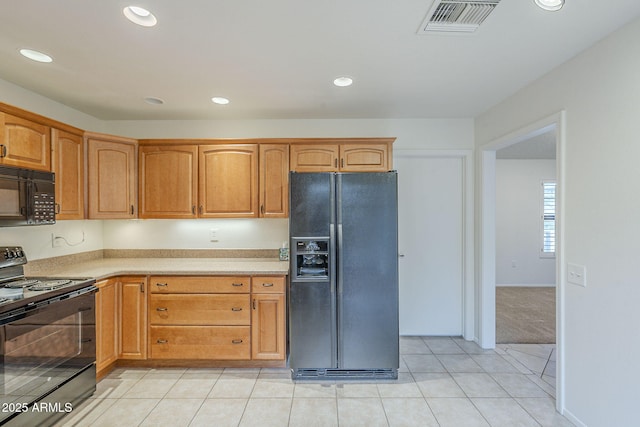 kitchen with light tile patterned flooring, light countertops, recessed lighting, visible vents, and black appliances