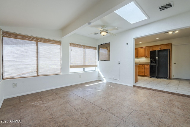 unfurnished living room with light tile patterned floors, baseboards, beamed ceiling, and visible vents