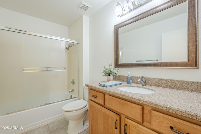 bathroom with vanity, toilet, tile patterned floors, enclosed tub / shower combo, and visible vents