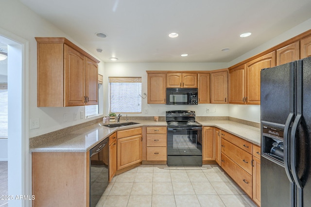 kitchen featuring recessed lighting, light countertops, a sink, light tile patterned floors, and black appliances