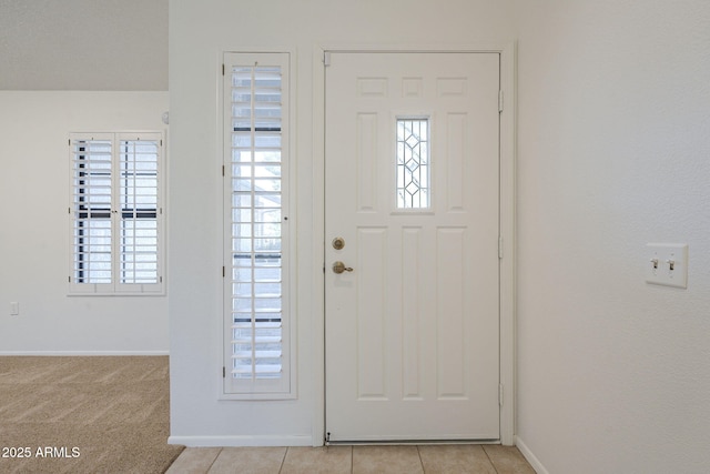 entryway featuring light tile patterned flooring and baseboards