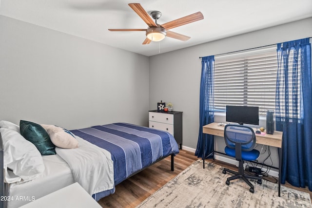 bedroom with ceiling fan and wood-type flooring