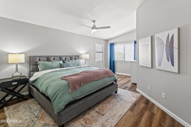 bedroom with ceiling fan, wood-type flooring, and lofted ceiling