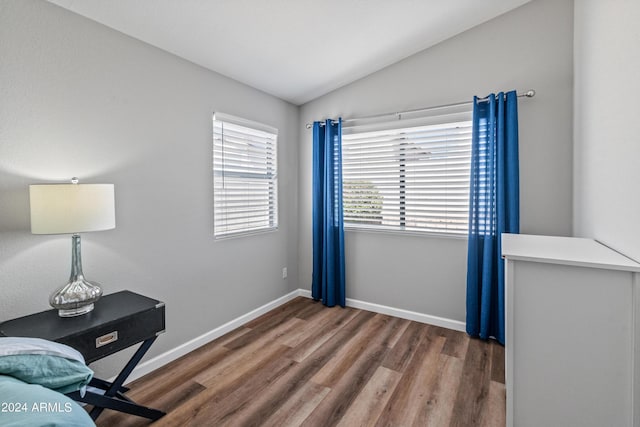 interior space with dark hardwood / wood-style floors and vaulted ceiling