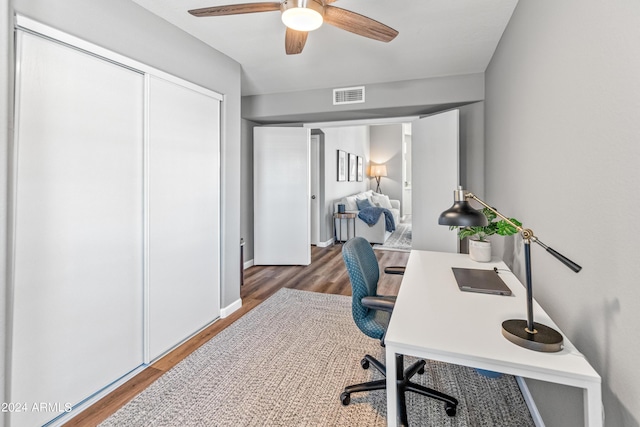 office space with dark hardwood / wood-style floors and ceiling fan