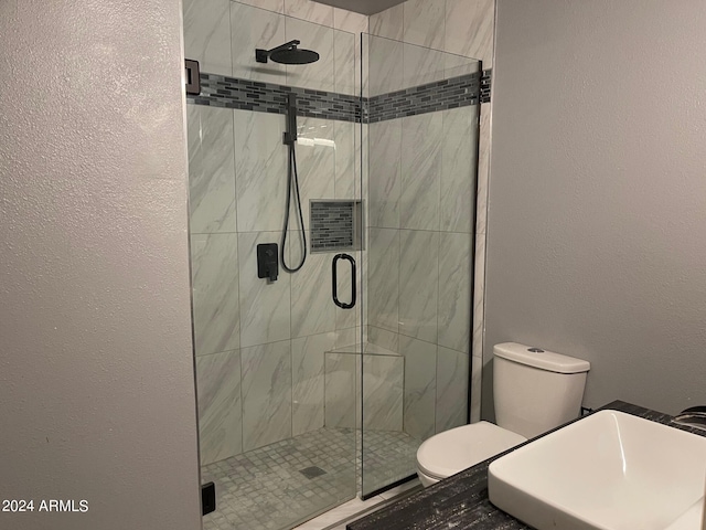 bathroom featuring an enclosed shower and toilet