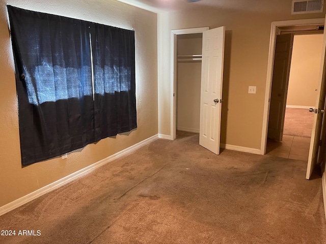 unfurnished bedroom featuring a closet and carpet