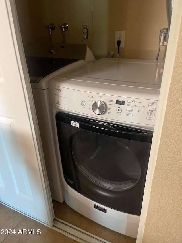 laundry area featuring tile patterned flooring and washer / clothes dryer