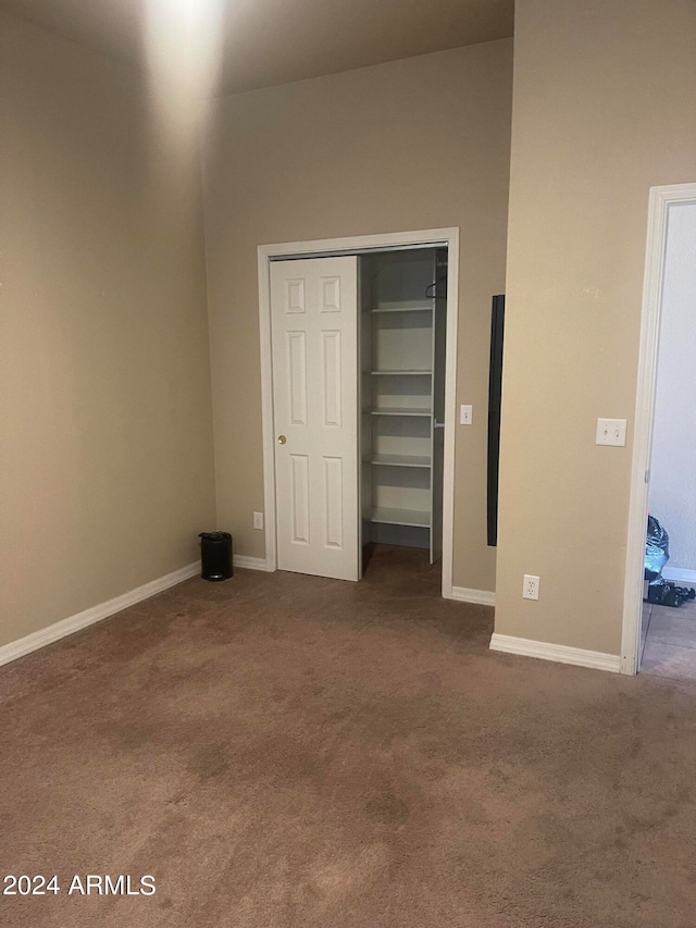 unfurnished bedroom with a closet and carpet flooring