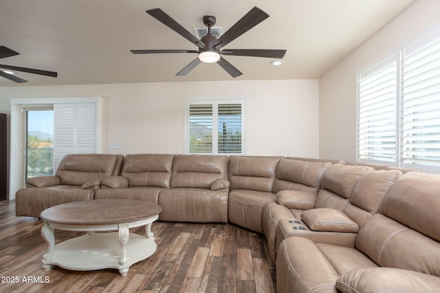 living room featuring ceiling fan, plenty of natural light, and dark hardwood / wood-style flooring