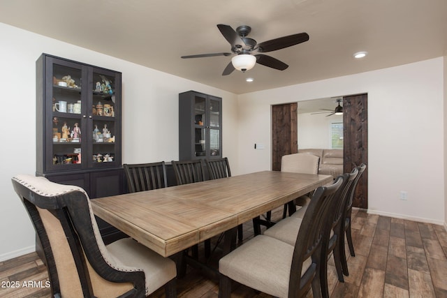 dining area featuring ceiling fan and dark hardwood / wood-style flooring