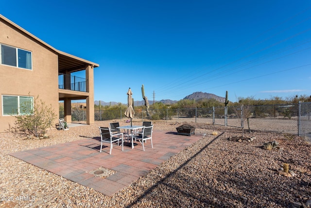 view of patio / terrace with a mountain view and a balcony