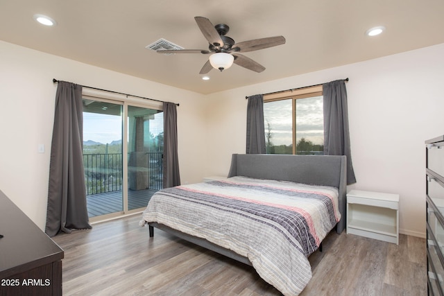 bedroom with ceiling fan, access to exterior, light wood-type flooring, and multiple windows