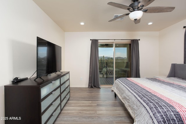 bedroom with ceiling fan, access to exterior, and wood-type flooring