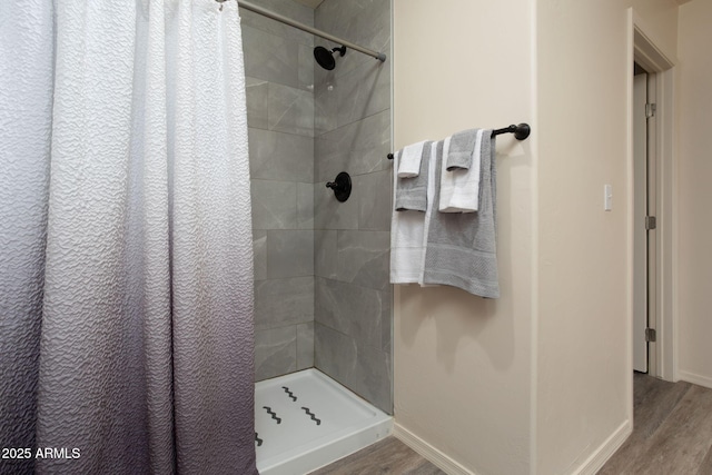 bathroom featuring hardwood / wood-style flooring and a shower with shower curtain