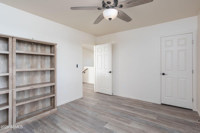 unfurnished bedroom featuring ceiling fan and wood-type flooring