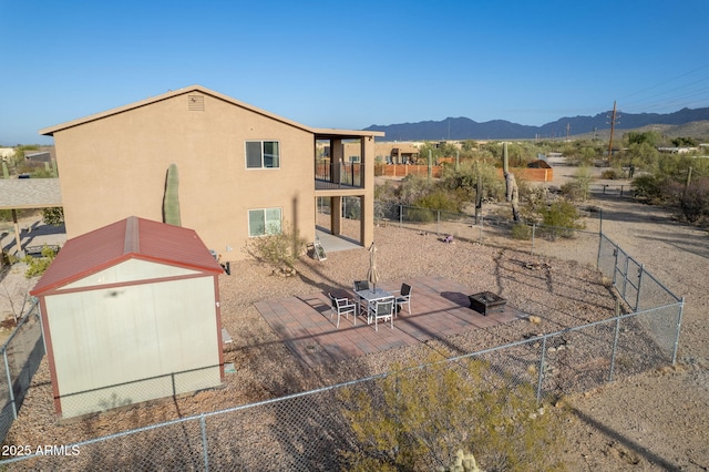 rear view of house featuring a balcony and a mountain view