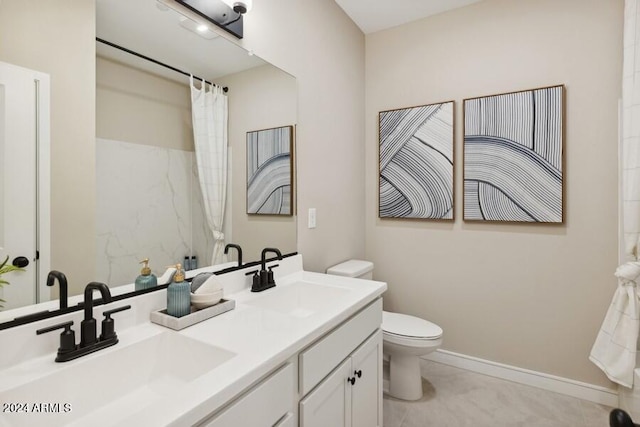 bathroom featuring curtained shower, vanity, and toilet