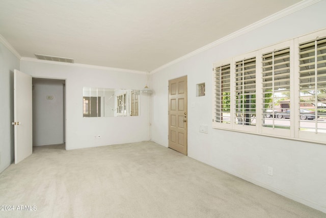 carpeted empty room with crown molding