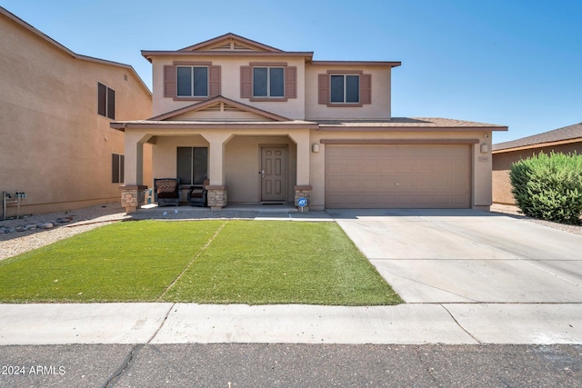 traditional-style house featuring stucco siding, covered porch, an attached garage, a front yard, and driveway