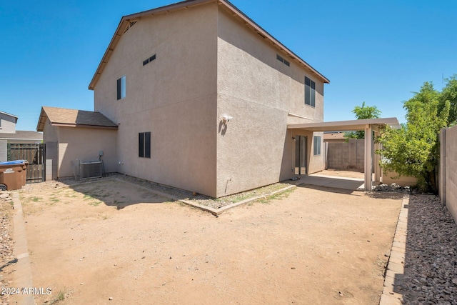 back of property with a patio, fence, cooling unit, and stucco siding