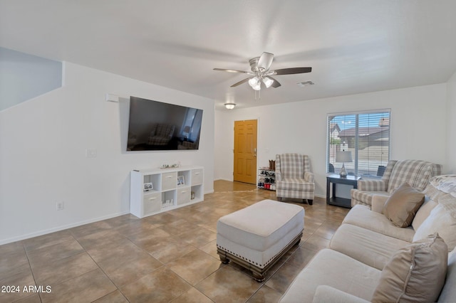 living room with ceiling fan, tile patterned flooring, visible vents, and baseboards