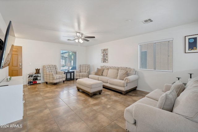 living room featuring visible vents, ceiling fan, baseboards, and light tile patterned floors