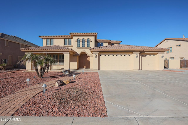 mediterranean / spanish-style home with a garage