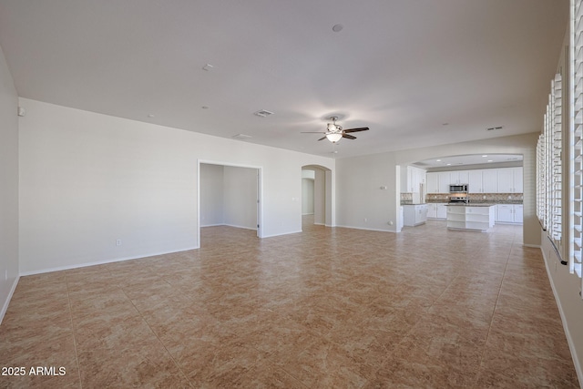 unfurnished living room with ceiling fan and light tile patterned floors