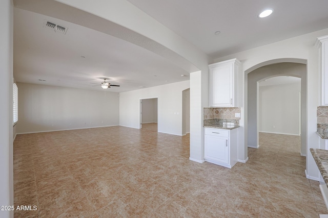 unfurnished living room featuring ceiling fan