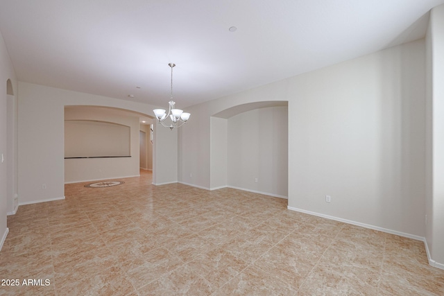 empty room with an inviting chandelier