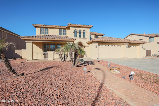 mediterranean / spanish-style home with a porch and a garage