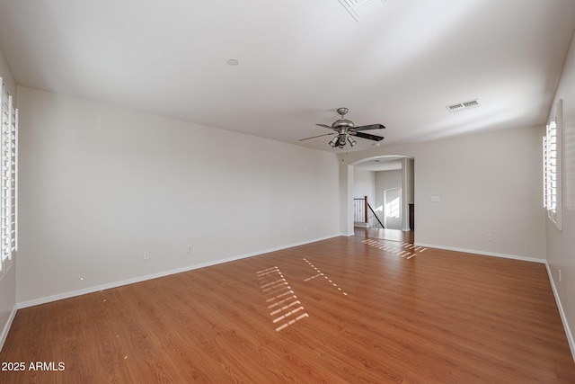 empty room with hardwood / wood-style floors and ceiling fan