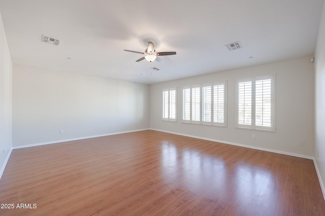 spare room featuring light hardwood / wood-style floors and ceiling fan