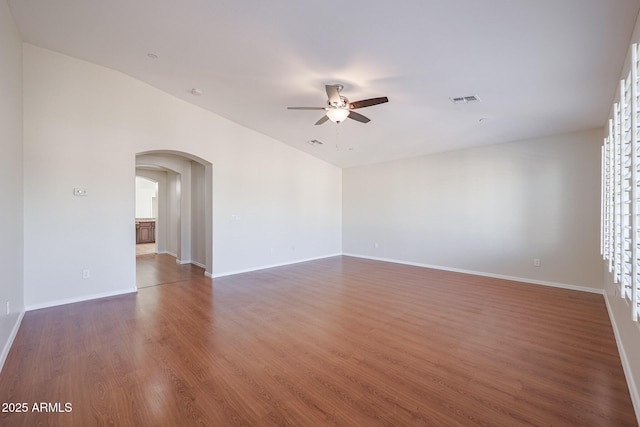 empty room featuring dark hardwood / wood-style flooring and ceiling fan