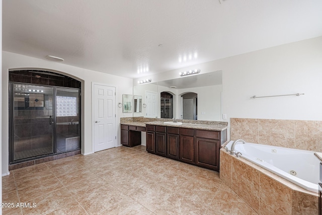 bathroom featuring vanity and shower with separate bathtub