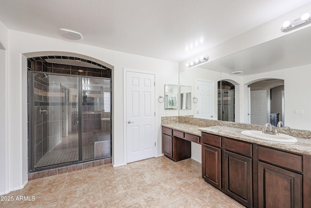 bathroom with vanity and an enclosed shower