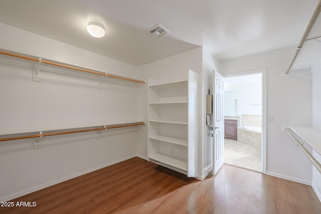 spacious closet with wood-type flooring