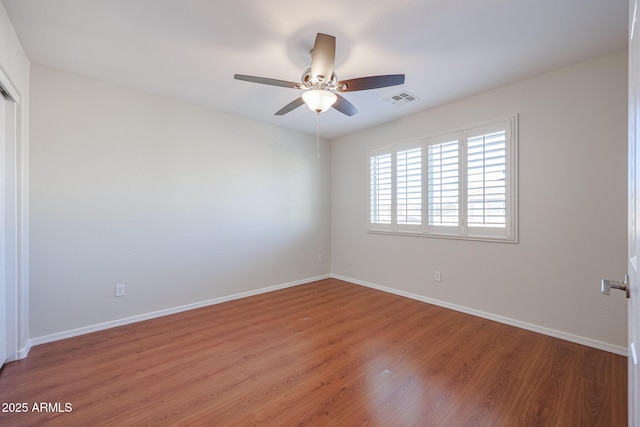 unfurnished room with hardwood / wood-style floors and ceiling fan