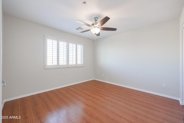 spare room featuring ceiling fan and hardwood / wood-style flooring