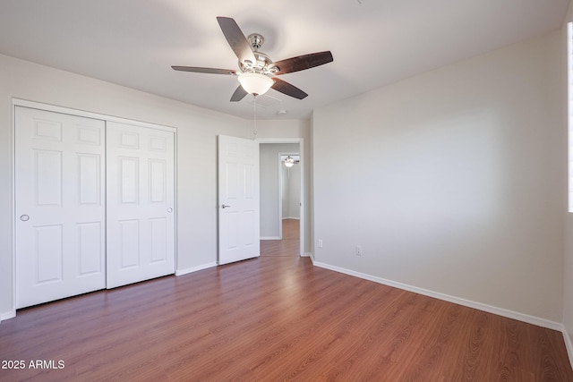 unfurnished bedroom featuring a closet, ceiling fan, and hardwood / wood-style floors