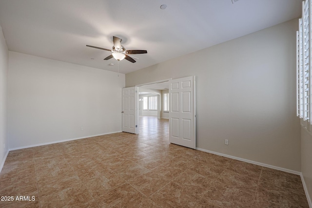 unfurnished room with ceiling fan