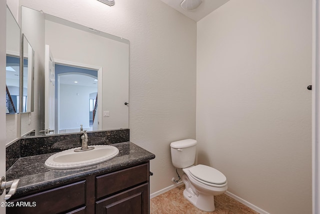 bathroom with tile patterned flooring, vanity, and toilet